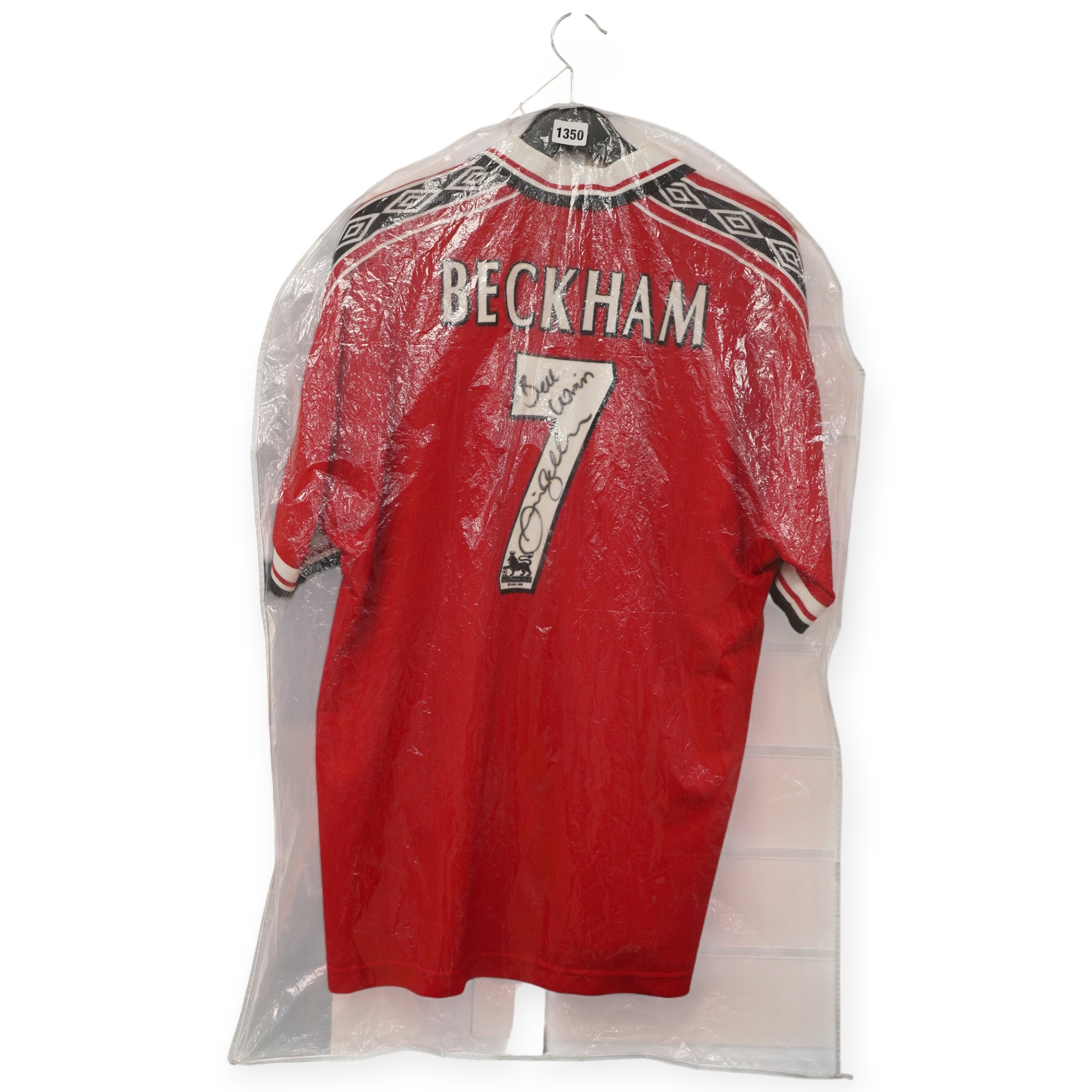 A Manchester United Umbro Sharp polo shirt, signed by David Beckham